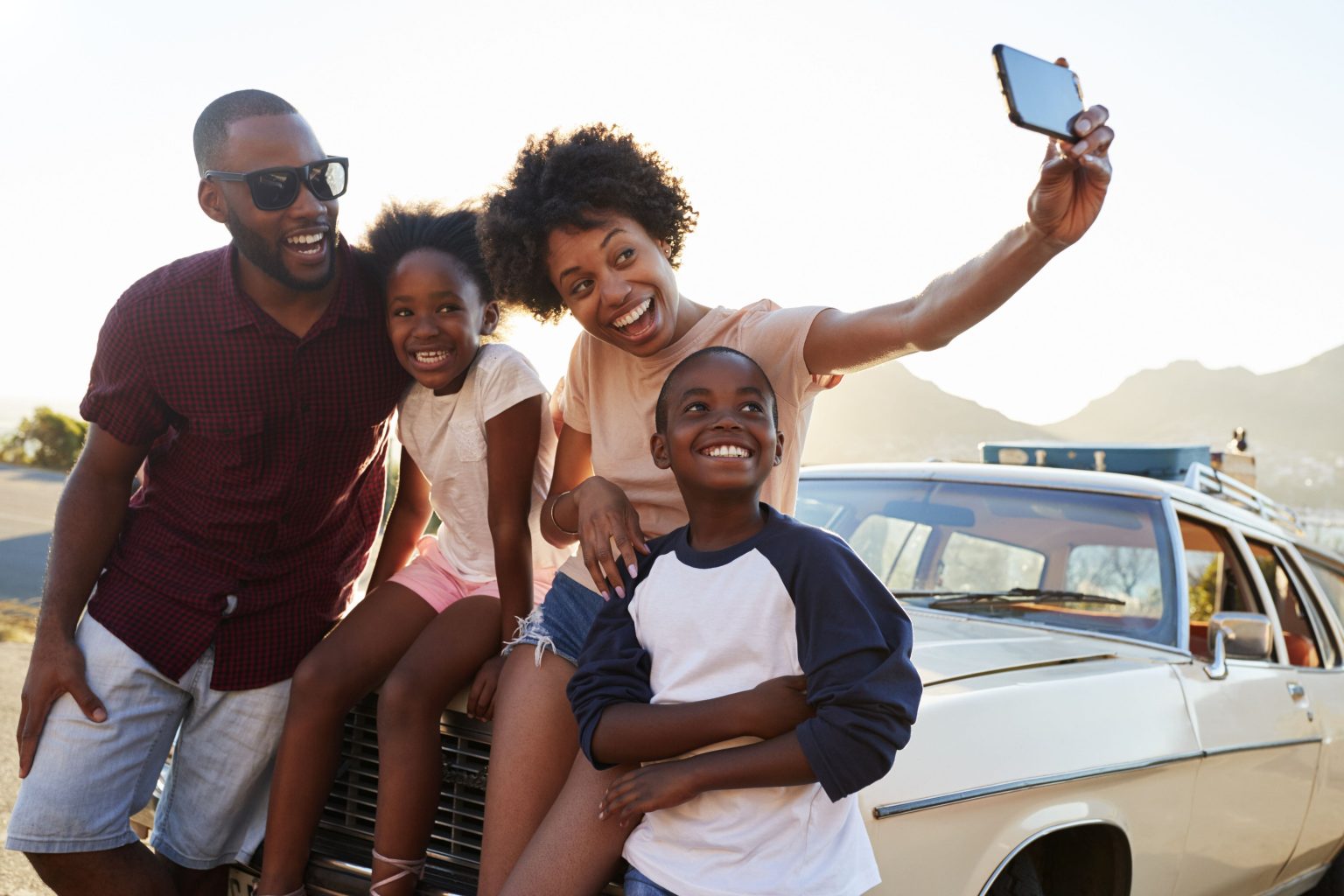 Rosenthal Family Of Four Taking A Selfie Atop A Car