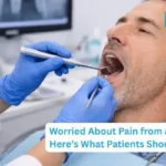 Dentist explaining dental bridge procedure and pain expectations to a patient