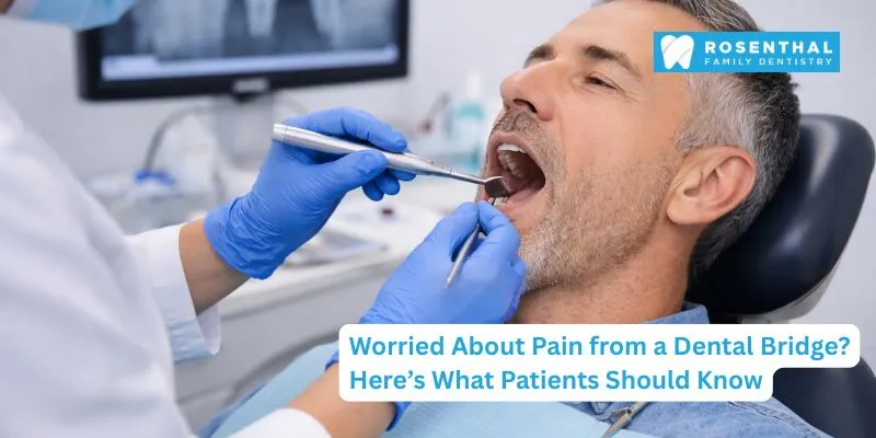 Dentist explaining dental bridge procedure and pain expectations to a patient