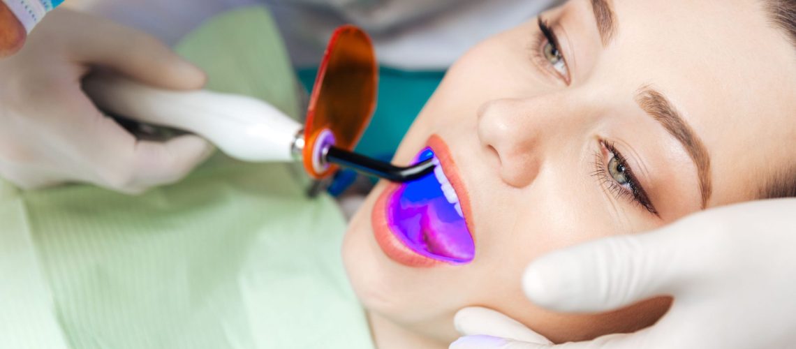 Rosenthal Family Dentistry - Woman doing laser whitening
